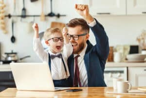 Cheerful businessman with kid celebrating success